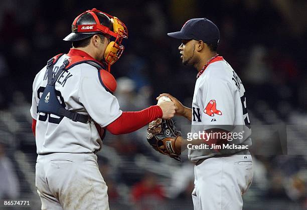 Ramon Ramirez of the Boston Red Sox takes the ball from teammate Jason Varitek before pitching against the New York Yankees on May 4, 2009 at Yankee...