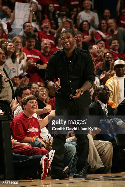 Recording artist Usher dances to some music during a timeout in the game between the Cleveland Cavaliers and the Atlanta Hawks in Game Two of the...
