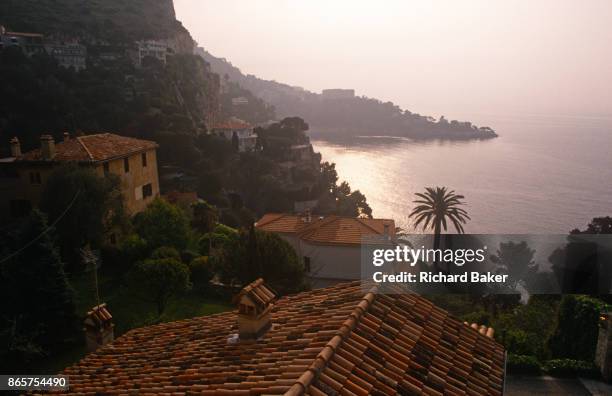 Landscape of rooftops and palm trees on the Cote d'Azur, on 13th April 1996, at Cap-d'Ail, France.