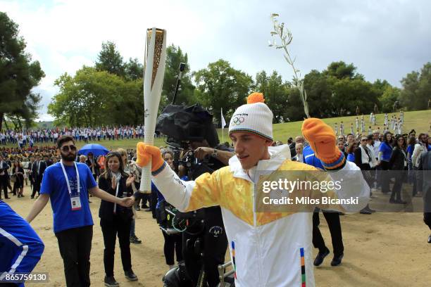 First Greek torchbearer for Pyeongchang 2018, cross-country skier Apostolos Angelis holds the Olympic flame during a lighting ceremony of the Olympic...