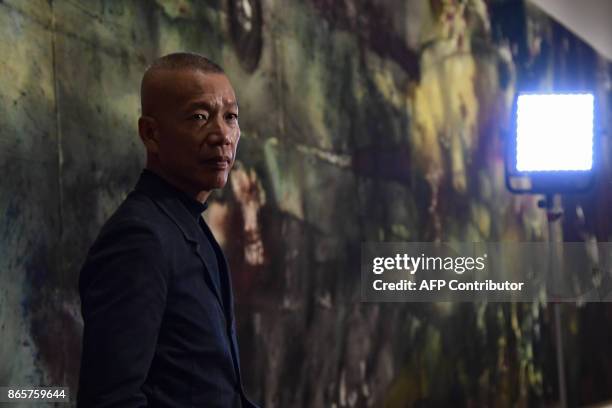 Chinese artist Cai Guo-Qiang poses during the presentation of his exhibition called "The Spirit of Painting" at El Prado museum in Madrid on October...