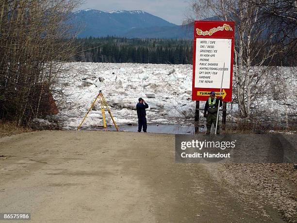 In this handout photo released by the Alaska State Troopers, members of the U.S. Geological Survey measure the water level of the flooded Yukon River...