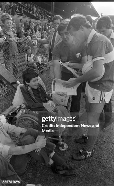 Irish International captain Laim Brady signs an autograph for Damien O'Donnell at Dalymount Park, circa August 1982. .