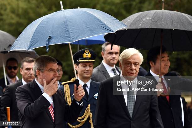 Greek President Prokopis Pavlopoulos and President of the International Oympic Committee Thomas Bach arrive at the Temple of Hera in Olympia, the...