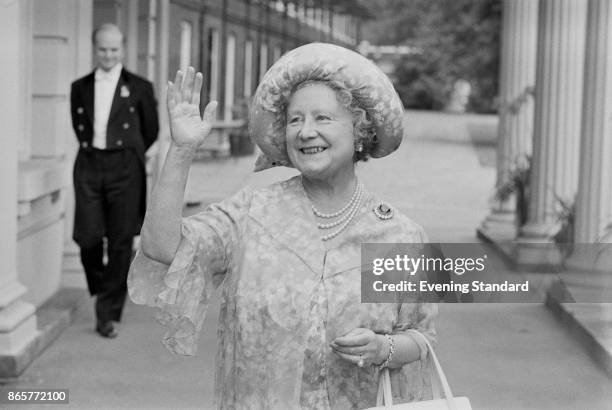 Queen Elizabeth, the Queen Mother , waves to the crowd who have gathered outside Clarence House, her London home, to wish her a happy 78th birthday,...