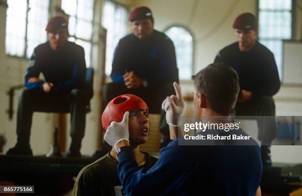 An physical education instructor tests an army recruit for concussion after a bout of Milling, a test of aggression that recruits must pass before...
