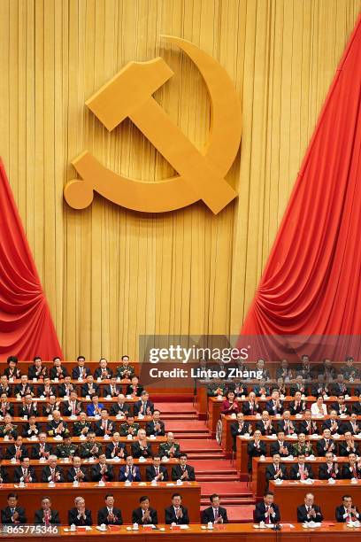 Chinese President Xi Jinping and other Chinese politicians and delegates applauds duirng the closing of the 19th Communist Party Congress at the...