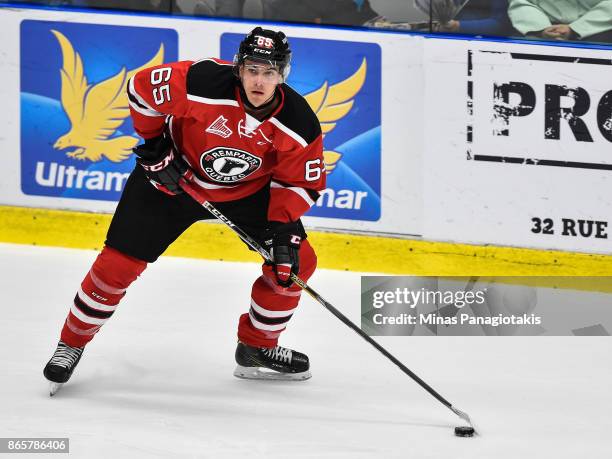 Louis-Filip Cote of the Quebec Remparts looks to play the puck against the Blainville-Boisbriand Armada during the QMJHL game at Centre d'Excellence...