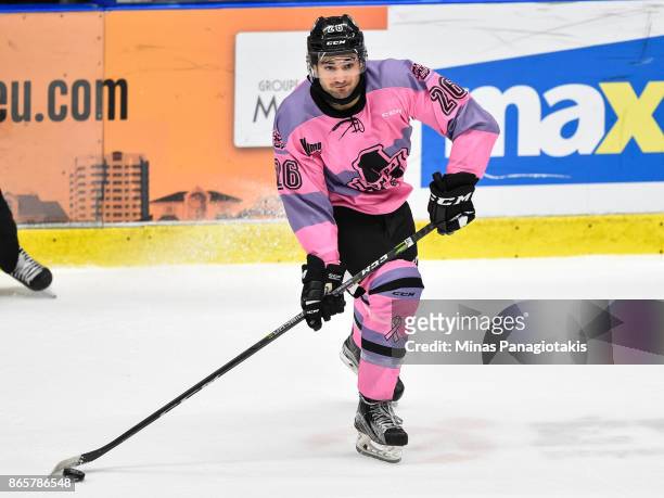 Ryan DaSilva of the Blainville-Boisbriand Armada looks to play the puck against the Quebec Remparts during the QMJHL game at Centre d'Excellence...
