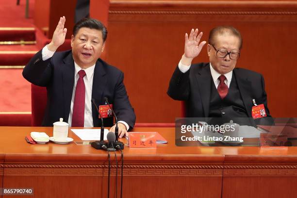 Chinese President Xi Jinping with China's former president Jiang Zemin vote at the closing of the 19th Communist Party Congress at the Great Hall of...