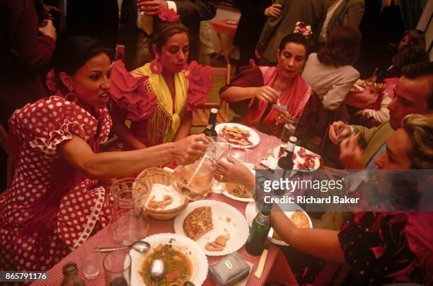 Spanish ladies feast at a private party in a marquee called a Caseta during the annual Feria de Abril, on 11th June 1999, in Seville, Andalucia,...