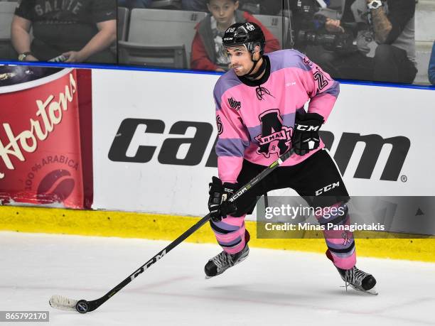 Ryan DaSilva of the Blainville-Boisbriand Armada looks to play the puck against the Quebec Remparts during the QMJHL game at Centre d'Excellence...