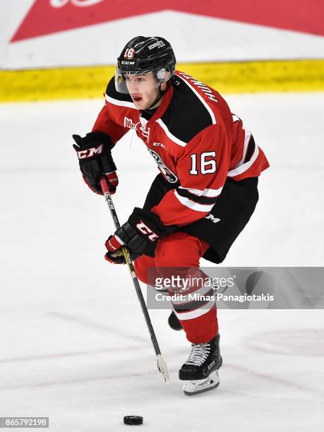 Christian Huntley of the Quebec Remparts skates the puck against the Blainville-Boisbriand Armada during the QMJHL game at Centre d'Excellence Sports...