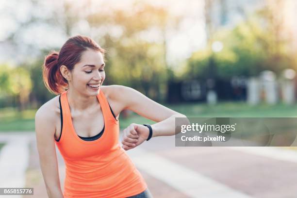 athlete checking the smart watch - light trace portrait stock pictures, royalty-free photos & images