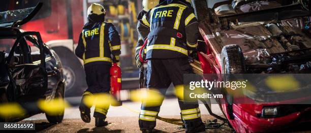 firefigters at a car accident scene - rescue worker stock pictures, royalty-free photos & images