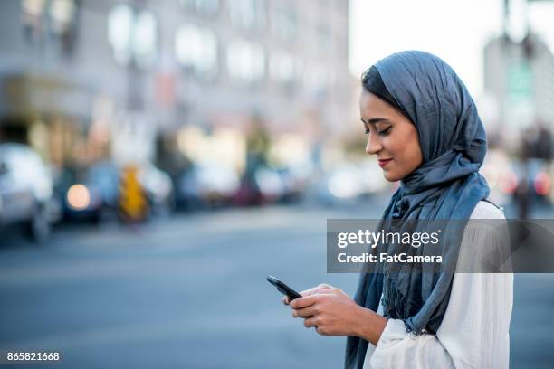 using technology - islam women stock pictures, royalty-free photos & images