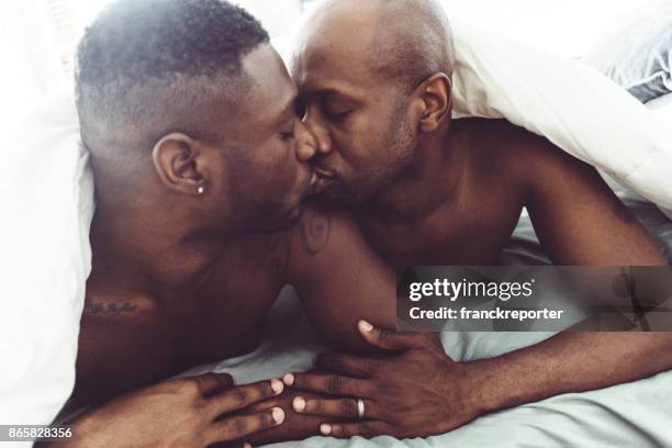 gay couple kissing and make sex in the bed