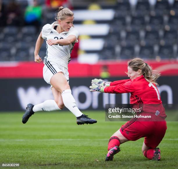 Tabea Kemme of Germany scores her team's third goal against goalkeeper Monika Biskopstoe of Faroe Islands during the 2019 FIFA Women's World...