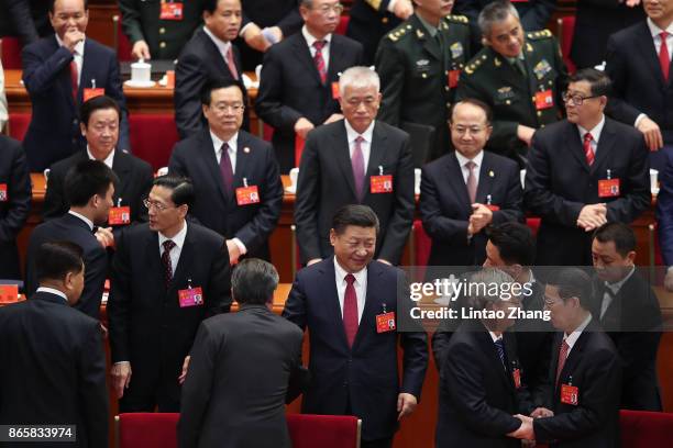 Chinese President Xi Jinping waves as he leaves after the closing of the 19th Communist Party Congress at the Great Hall of the People on October 24,...