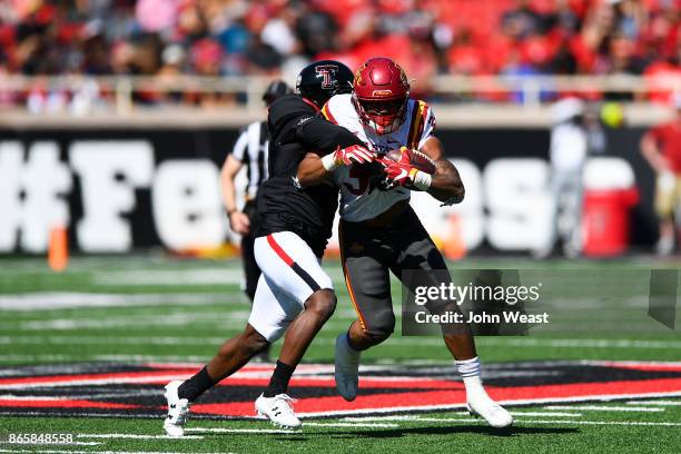 David Montgomery of the Iowa State Cyclones is wrapped up and tackled by Octavious Morgan of the Texas Tech Red Raiders during the game on October...