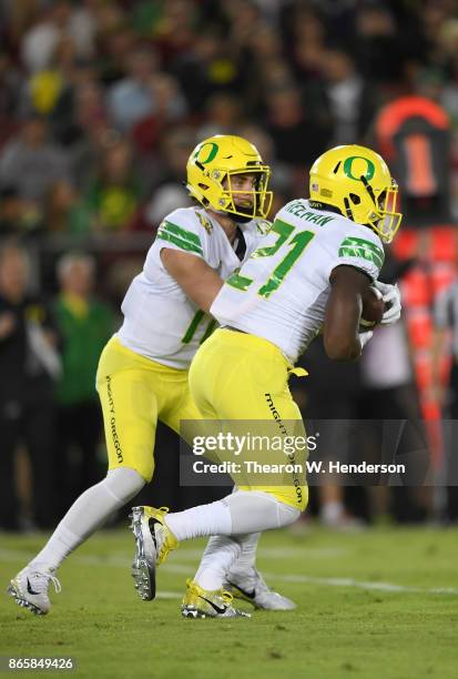 Royce Freeman of the Oregon Ducks carries the ball against the Stanford Cardinal during the first quarter of their NCAA football game at Stanford...