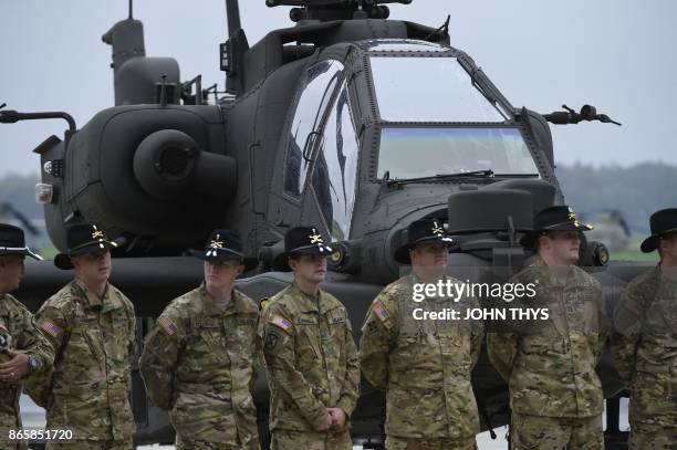 Soldiers from the US Army 1st Cavalry Brigade, 1st Cavalry Division, stand in front of AH-64 Apache helicopters on the tarmac at Shape Airfield at...