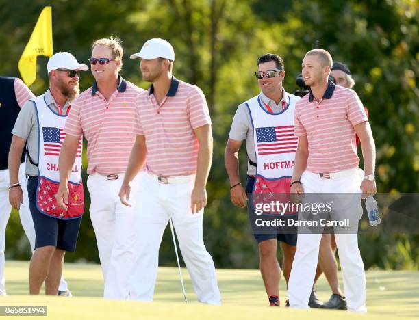 Caddie Joe Greiner, Charley Hoffman, Kevin Chappell, caddie Brett Waldman and Daniel Berger of the U.S. Team walk off the 13th green during the...