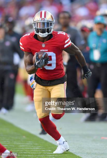 Aldrick Robinson of the San Francisco 49ers runs with the ball after catching a pass against the Dallas Cowboys during their NFL football game at...