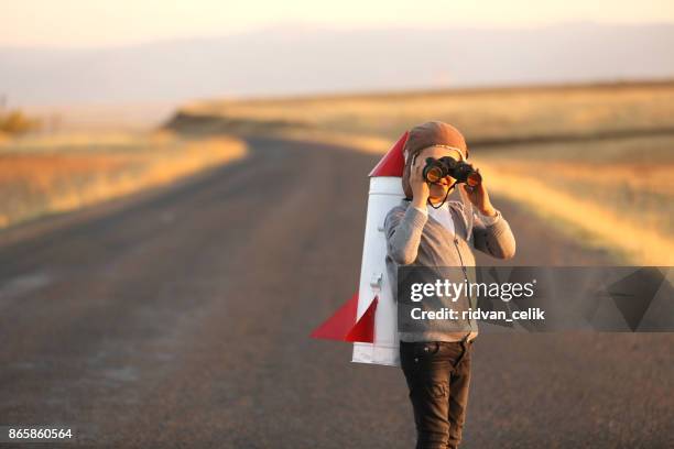 rocket child is looking at binoculars - retro spaceship stock pictures, royalty-free photos & images