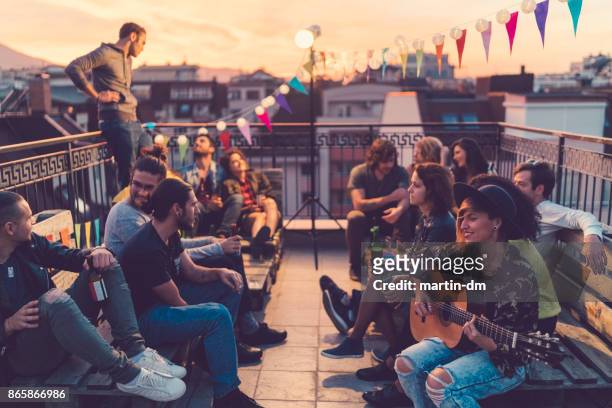 rooftop party - martin guitar stock pictures, royalty-free photos & images
