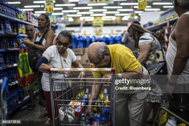 Customer places cleaning supplies in a shopping cart during a discount event at a Supermercado Guanabara SA store in Rio de Janeiro, Brazil, on...