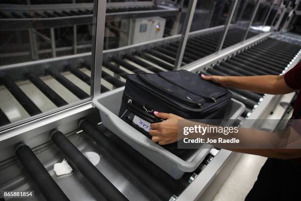 Bag is cleared through an automated screening lane funded by American Airlines and installed by the Transportation Security Administration at Miami...