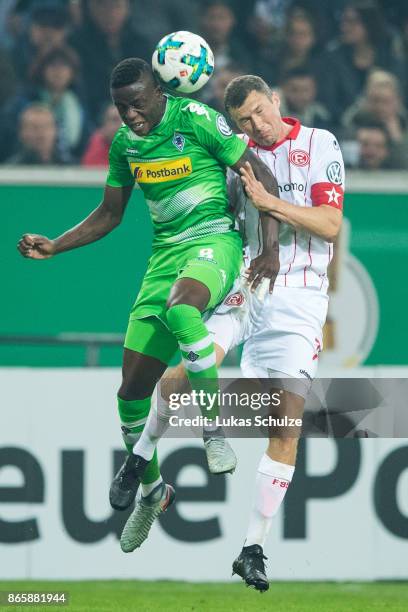 Denis Zakaria of Moenchengladbach and Oliver Fink of Duesseldorf head the ball during the DFB Cup match between Fortuna Duesseldorf and Borussia...