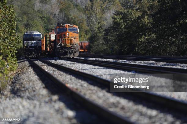 Norfolk Southern Corp., left, and Burlington Northern Santa Fe LLC locomotives sit parked in Burnside, Kentucky, U.S., on Tuesday, Oct. 17, 2017....
