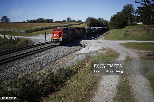 Canadian National Railway Co. Locomotives lead a Norfolk Southern Corp. Freight train through Winfield, Tennessee, U.S., on Tuesday, Oct. 17, 2017....