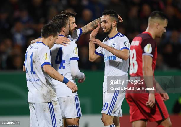 Guido Burgstaller of Schalke celebrates with his team-mates after scoring his team's second goal during the DFB Cup match between SV Wehen Wiesbaden...