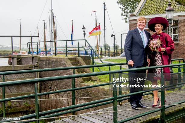 King Willem-Alexander of The Netherlands and Queen Maxima of The Netherlands pose at the water pomp system Gemaal Eemnes during there region visit to...