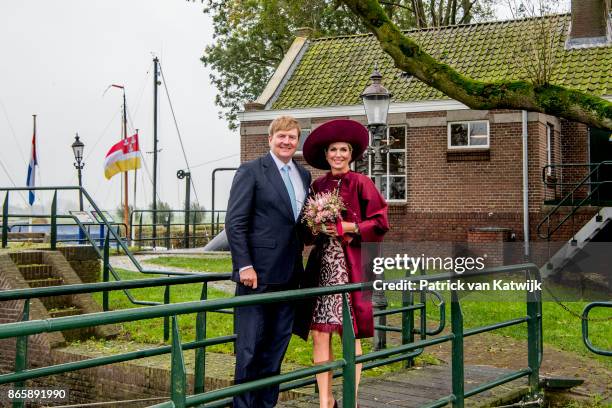 King Willem-Alexander of The Netherlands and Queen Maxima of The Netherlands pose at the water pomp system Gemaal Eemnes during there region visit to...