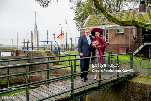 King Willem-Alexander of The Netherlands and Queen Maxima of The Netherlands pose at the water pomp system Gemaal Eemnes during there region visit to...