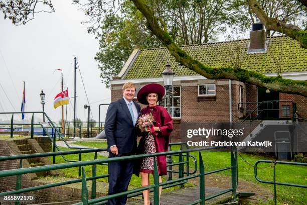 King Willem-Alexander of The Netherlands and Queen Maxima of The Netherlands pose at the water pomp system Gemaal Eemnes during there region visit to...