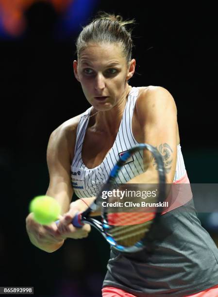 Karolina Pliskova of Czech Republic plays a backhand in her singles match against Garbine Muguruza of Spain during day 3 of the BNP Paribas WTA...