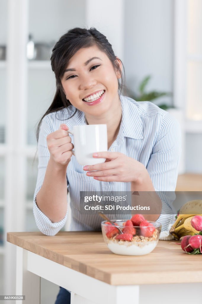 Cheerful woman enjoys healthy food break