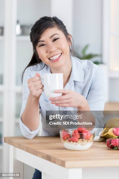 cheerful woman enjoys healthy food break - lap body area stock pictures, royalty-free photos & images