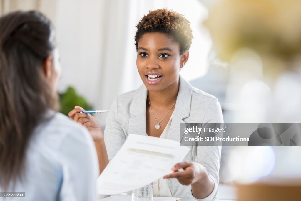 Businesswomen meet to discuss document