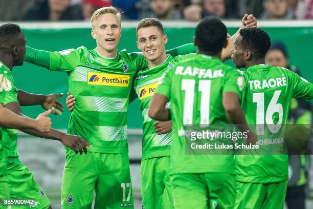 Oscar Wendt , scorer Thorgan Hazard and team mates of Moenchengladbach celebrate their teams first goal during the DFB Cup match between Fortuna...
