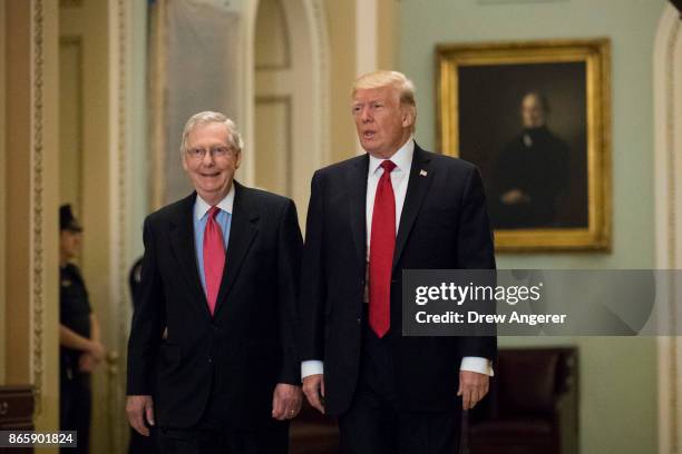 President Donald Trump and Senate Majority Leader Mitch McConnell walk to a lunch with Senate Republicans on Capitol Hill, October 24, 2017 in...