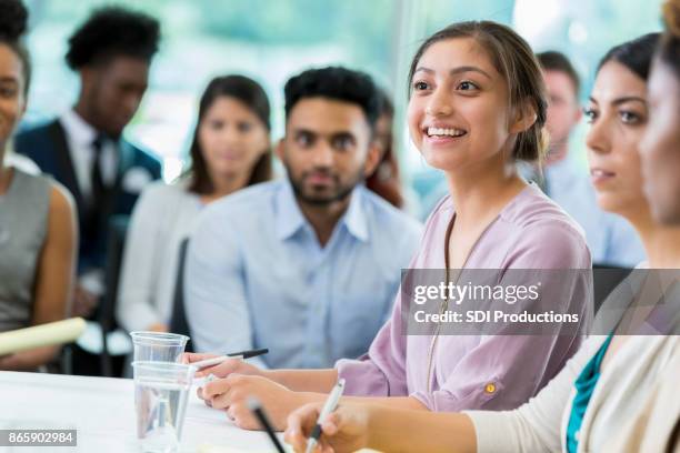 attentive professional woman attends business seminar - panel discussion stock pictures, royalty-free photos & images