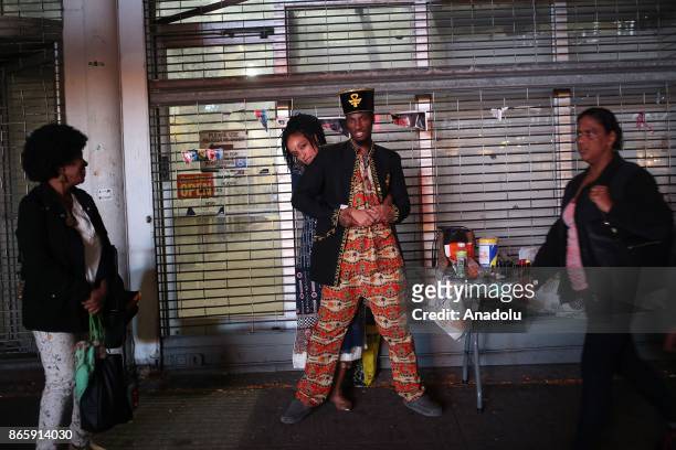 Bastet and Abdul pose for a photo on 125th street of Harlem neighborhood of New York City, United States on October 20, 2017. 116th street is long...