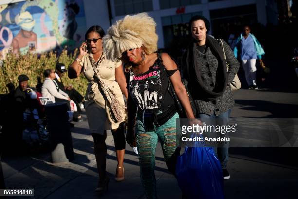 People walk on the 125th street of Harlem neighborhood of New York City, United States on October 20, 2017. 116th street is long known for it's jazz...