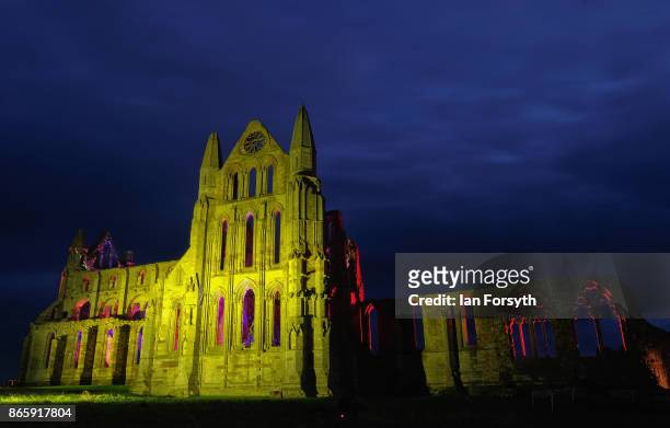 Light display illuminates the ruins of the historic Whitby Abbey on October 24, 2017 in Whitby, England. The famous Benedictine abbey was the...